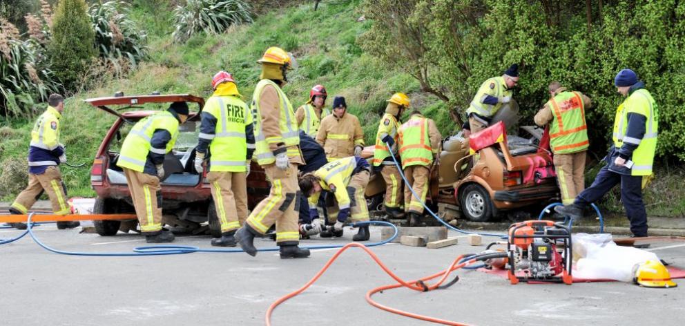 Firefighters from Willowbank, Lookout Point, Mosgiel and St Kilda stations take part in a training exercise cutting ''patients'' from vehicles in a simulated motor vehicle accident beside the Carisbrook site in Dunedin. Photo by Linda Robertson