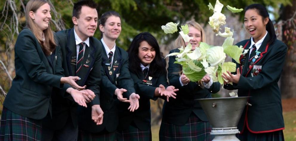 Kaikorai Valley College pupils and Kaika Energy directors (from left) Johanna Hall, Regan Gilchrist, Paige Gilder, Deanna Teremoana (all 17), Kate Shaw (18) and Sophia Taing (17) toss food waste into the school's Urban Digestor, which can turn food scraps