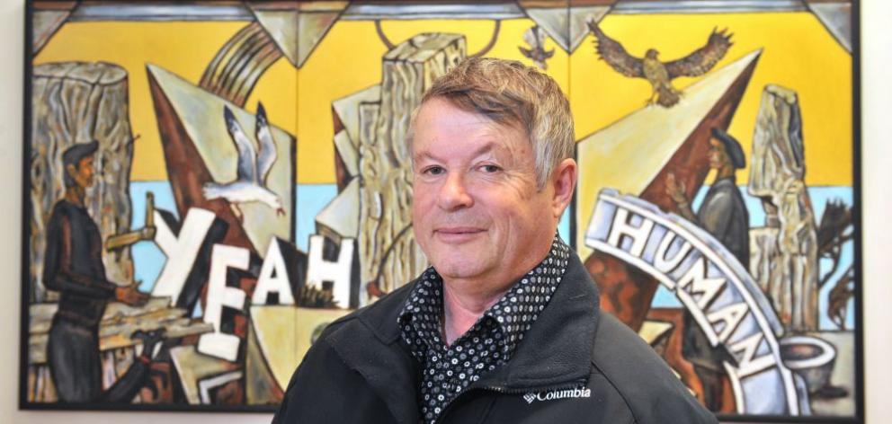  ''I have agendas but I can explore quite opposite things in a series,'' Nigel Brown says. Behind the artist is his work “Yeah human”.