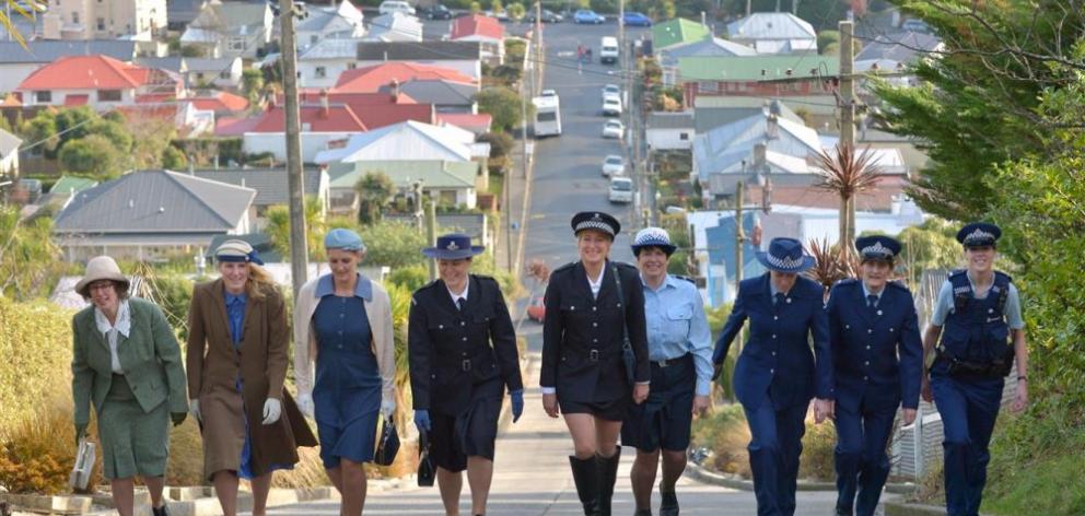 Walking up Baldwin St yesterday in honour of the 75th anniversary of women in policing are (from left) Jackie Hibbard in a 1940s uniform, Senior Constable Tracy Turner (50s uniform), Constable Virginia Miller (60s uniform), Constable Rebekah Kitto (70s un