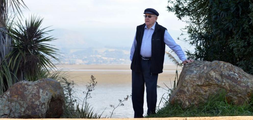 Warrington resident Alistair Wright with the rocks blocking an access track to Blueskin Bay that are to be removed after a council decision yesterday. Photo by Peter McIntosh. 