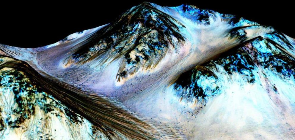 Dark, narrow, 100m-long streaks on Mars  are believed to have been formed by flowing water and are seen in this image produced by NASA, the Jet Propulsion Laboratory  and the University of Arizona. Photo: NASA/JPL/University of Arizona/Reuters