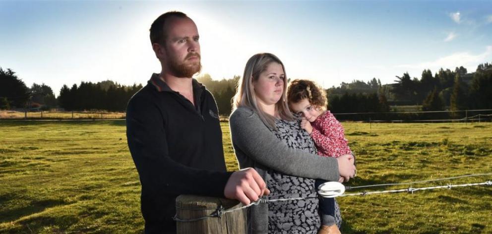 David Griffiths with fiancee Megan Macaulay and their daughter Quinn on land where they planned to build in Halfway Bush. Photo: Peter McIntosh
