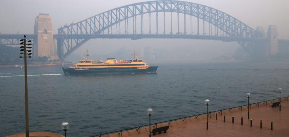 Smoke shrouds the Sydney Harbour Bridge on Thursday. Photo: Getty Images 