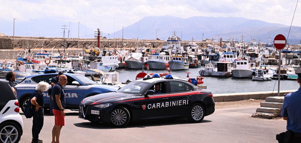 Italian Carabinieri patrol the port of Porticello in Sicily. Photo: Getty Images