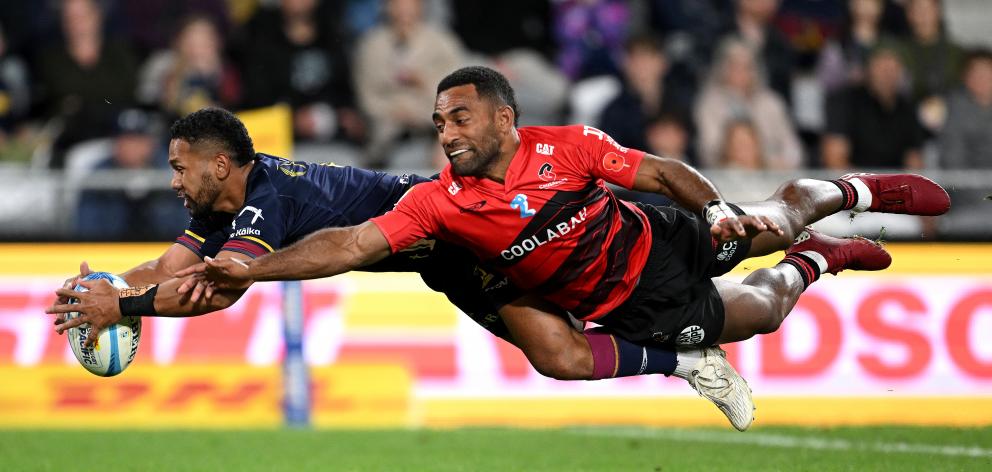 Folau Fakatava of the Highlanders and Sevu Reece of the Crusaders compete for the ball. Photo:...