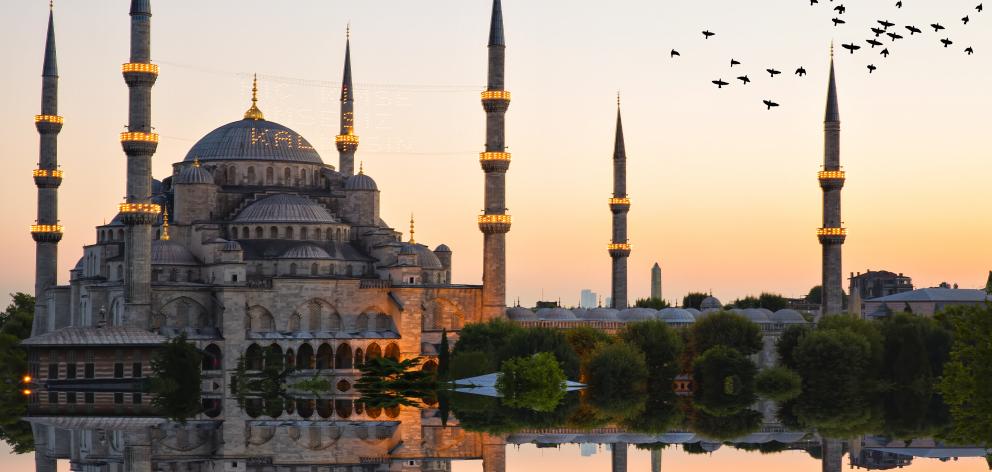 Istanbul’s Blue mosque and Hagia Sophia is reflected by calm water. Photo: Getty Images