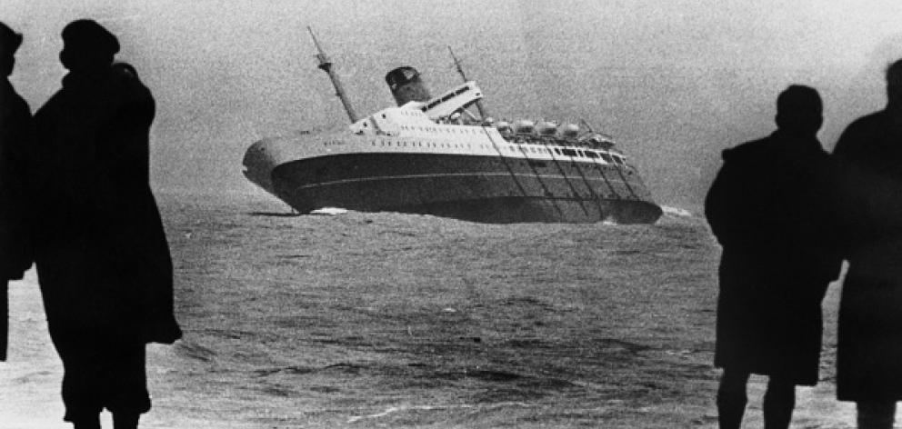 People watch from shore as the Wahine capsized after striking a reef on April 10, 1968. The ferry...