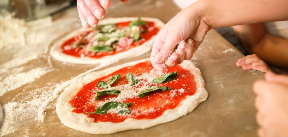 Fresh basil and a rich tomato sauce are essential ingredients of a Margherita pizza. Photo: Getty...