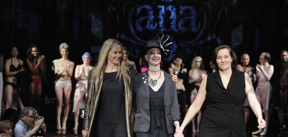 From left: actress Mira Sorvino, #Cancerland Champagne Joy and Anaono founder Dana Donofree walk the runway. Photo: Getty Images 