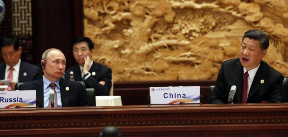 Russian President Vladimir Putin (left) listens to Chinese President Xi Jinping. Photo: Getty...