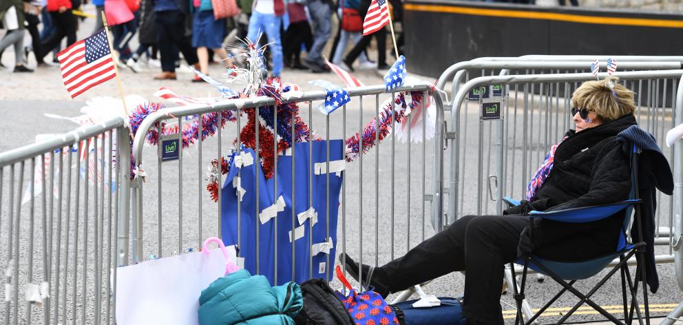 A Royal fan from the US secures her position near Windsor Castle four days ahead of the wedding....