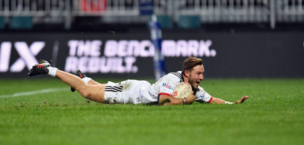 Mitchell Hunt of the Crusaders dives over to score a try against the French Barbarians in...