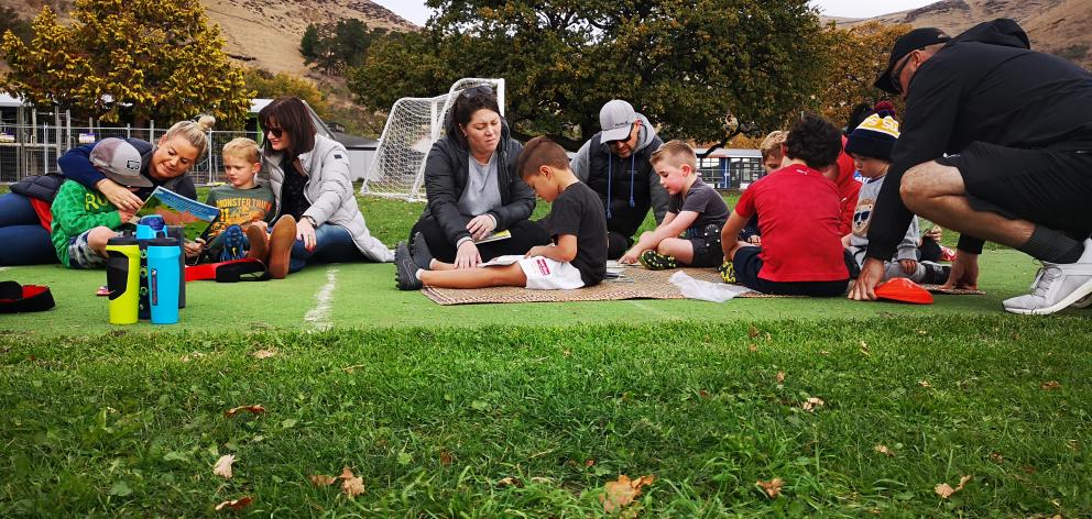 Children and parents reading before training. Photo: Supplied