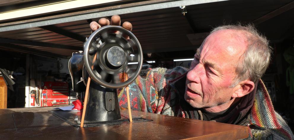 Phil Garrett repairs a Singer sewing machine. Garrett found a leather-work specialist who could...