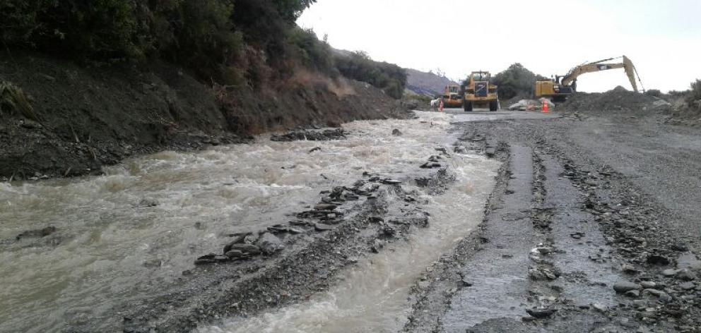Contractors work to clear Glenorchy Road from mud and debris on Sunday. Photo: QLDC