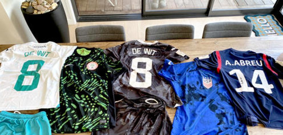 Amber De Wit’s souvenirs from the World Cup – her NZ away kit, a Nigeria home kit, her NZ home...