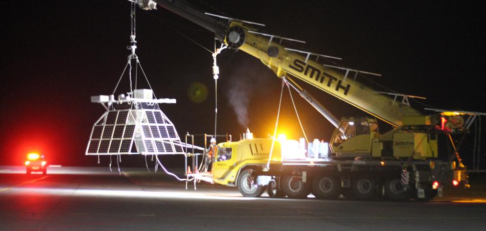 A crane takes the payload out to the site this morning. Photo: Aspen Bruce