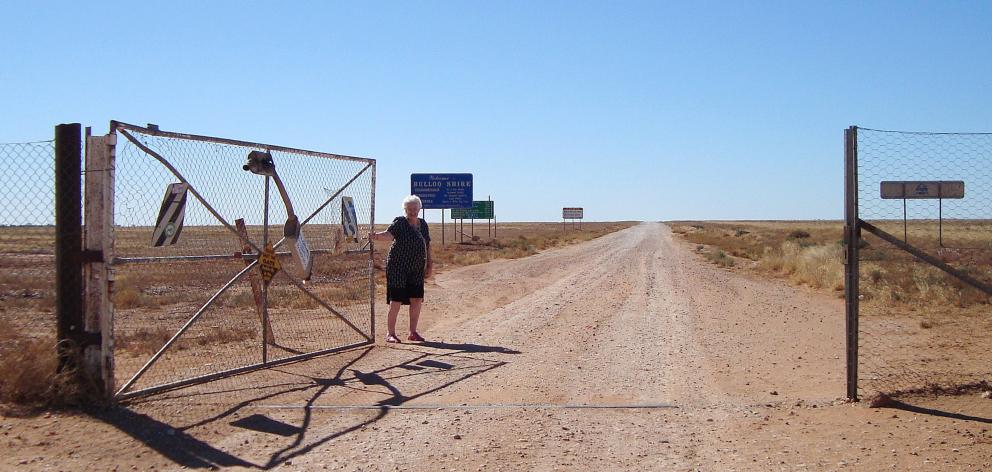 Judi Charteris swings open the border gate on an Outback gravel road between New South Wales and...