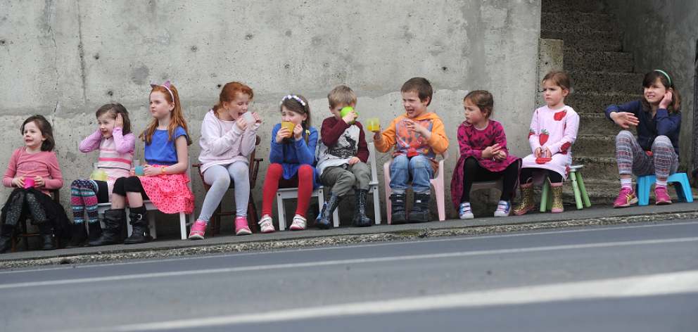 Watching the Special Rigs for Special Kids convoy on Taieri Rd yesterday are (from left) Lila...