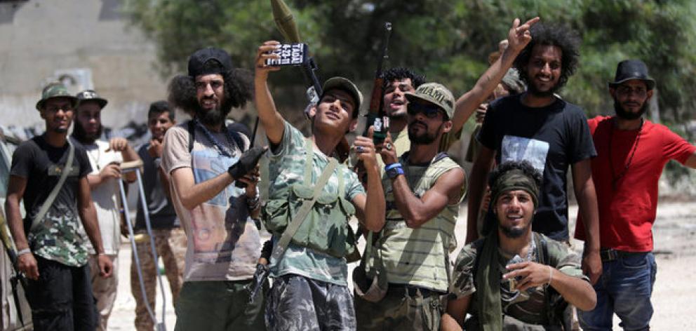 Members of the Libyan army's special forces take a selfie before entering the area of clashes with Islamist militants in their last stronghold in Benghazi. Photo: Reuters
