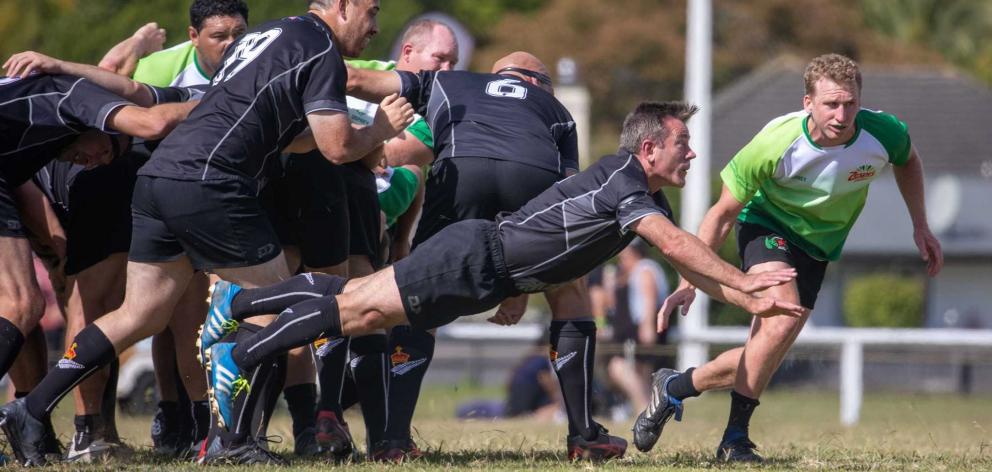 Michael Woodhouse performs a dive pass while playing halfback for the parliamentary rugby team....