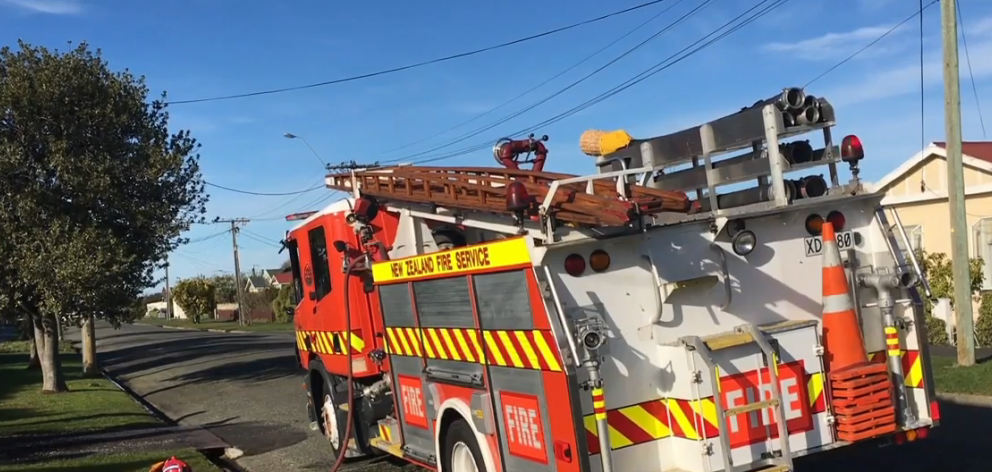 Fire fighters attend a house fire in Oamaru. Photo: Shannon Gillies