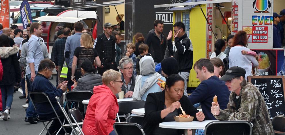 New Year's Eve party-goers enjoy a bite from the food trucks in George St. Photo: Gerard O'Brien