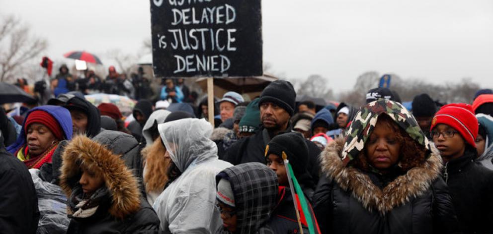 Activists pray during the National Action Network's "We Shall Not Be Moved" march in Washington,...