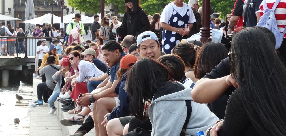 Visitors enjoy the sun and a cool breeze on Queenstown's lakefront this evening. Photo: Guy Williams