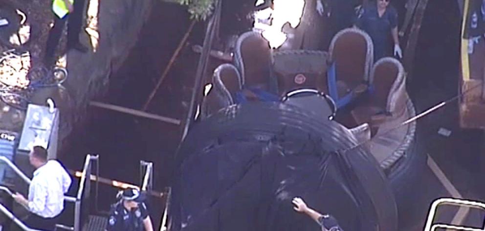 In this image made from video, rescue personnel stand by the Thunder River Rapids ride at...