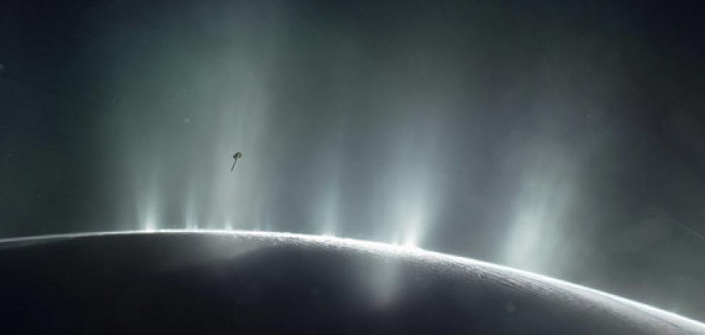 Nasa's Cassini spacecraft is shown diving through the plume of Saturn's moon Enceladus. Photo: Reuters