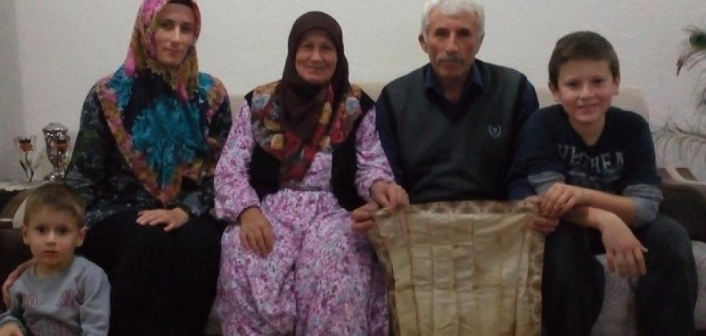 The Oz family with the handkerchief that has been in the family for more than 100 years. Photo:...