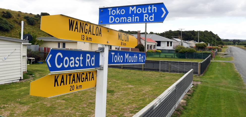 Signposts at Toko Mouth give directions to nearby towns.