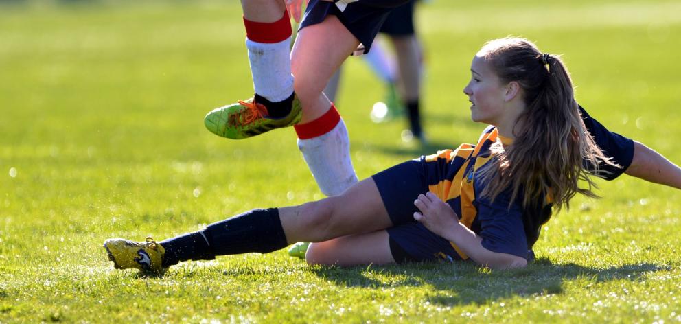 Elsie Anderson, of Wakatipu High School, makes a tackle