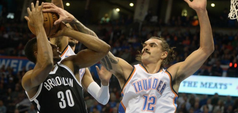 Kiwi basketballer Steven Adams, playing for the Oklahoma City Thunder, blocks Thaddeus Young of...