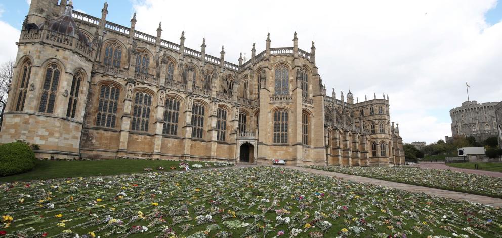 Flowers outside St George's Chapel where Prince Philip's funeral will be held on Saturday. Photo:...