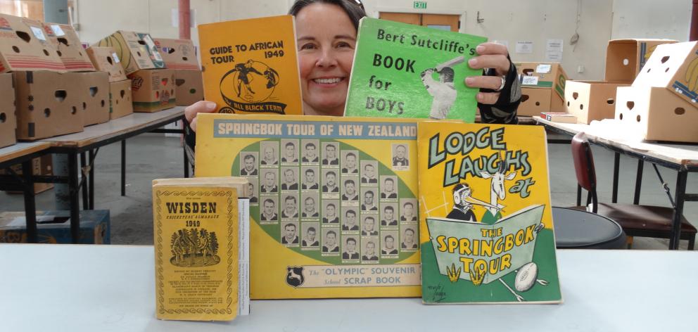 Alison  Cunningham displays some of the sporting books  from Peter Sellers’ collection which will...