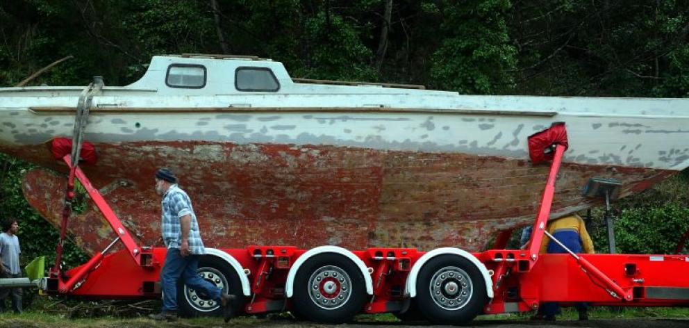 The 120-year-old racing keeler Atalanta emerges from a storage shed in Port Chalmers, bound for a new life with the Wellington Classic Yacht Trust. Photo by Peter McIntosh.