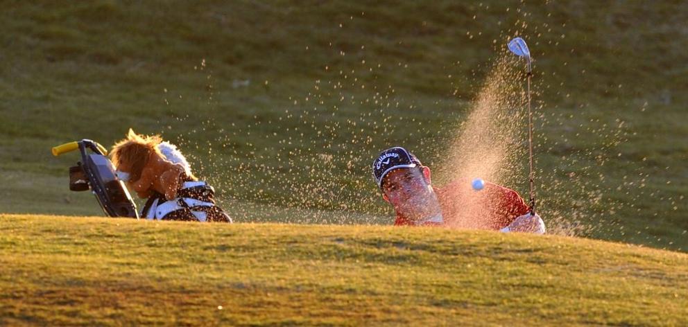 Queenstown golfer Mark Brooks hits out of a bunker on the 18th hole during the second Otago men's trial at Chisholm Park yesterday. Photo by Craig Baxter.