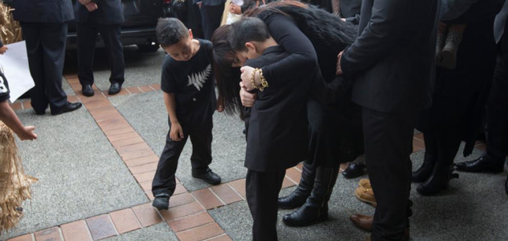 Nadene Lomu holds her boys as family and friends gather to farewell Jonah Lomu. Photo: NZ Herald