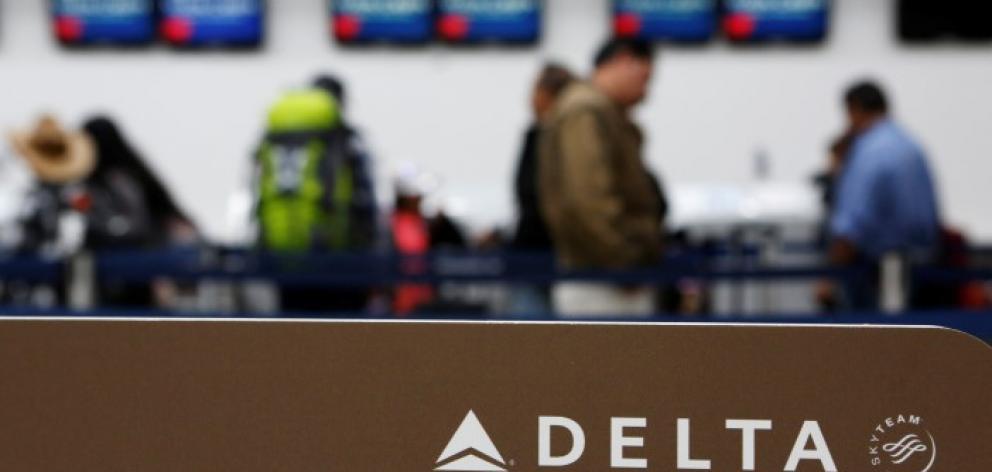 Passengers check in at a counter of Delta Air Lines in Mexico City. Photo Reuters