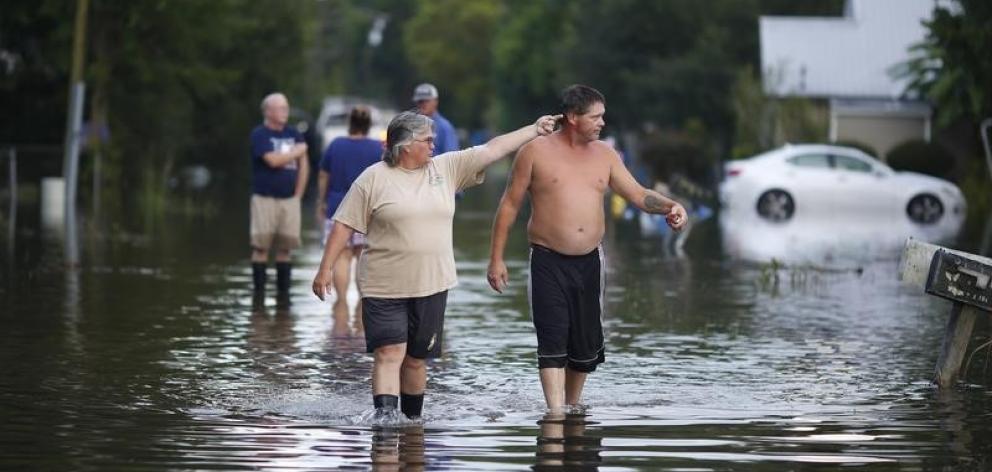 Residents survey flooding after heavy rains in Sorrento, Louisiana. Photo Reuters