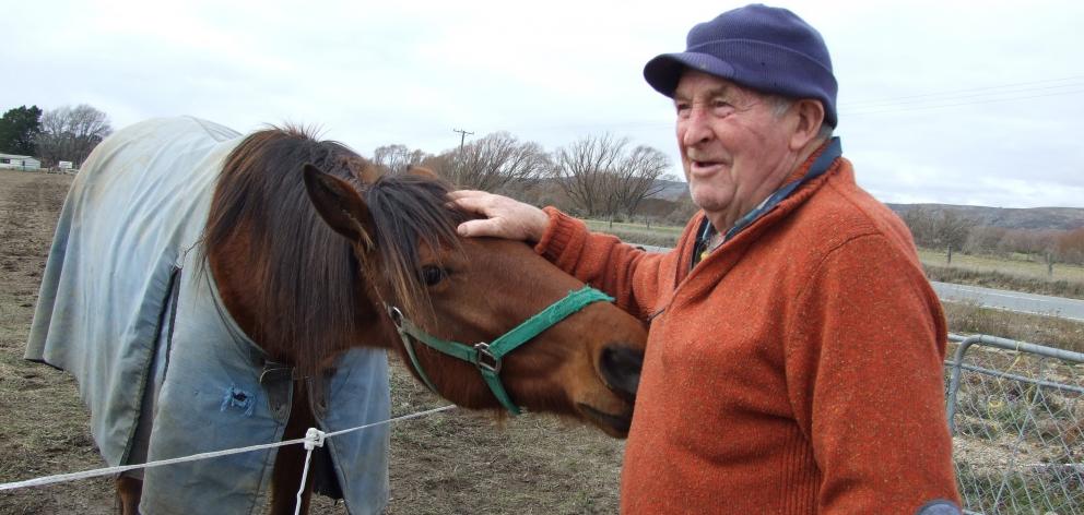Ginger Woodhouse reflects on his rise to stardom in a TV commercial as he strokes trotter Special Pat in Omakau. Photo by Lynda van Kempen.