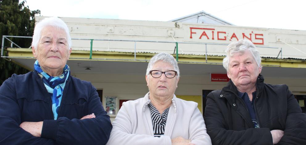 Millers Flat residents Carol McDonald (left), Lyn Owens and Margaret Paterson say a closed Faigan's Store is causing their village to die. Photo by Jono Edwards.