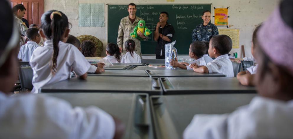 Cpl. Anatoliy Derepa, a member of the New Zealand Defence Force educates local Timorese children....