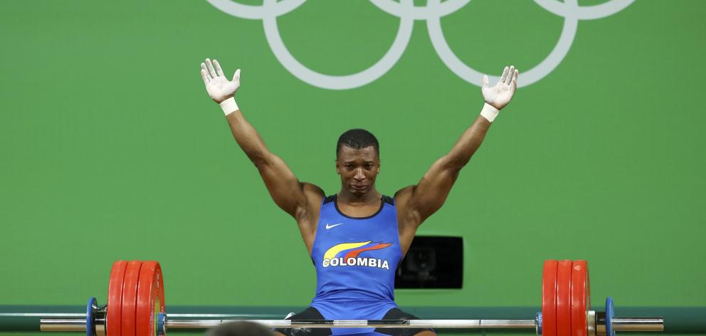 Oscar Figueroa (COL) of Colombia reacts after winning the gold medal in the Men's 62kg...