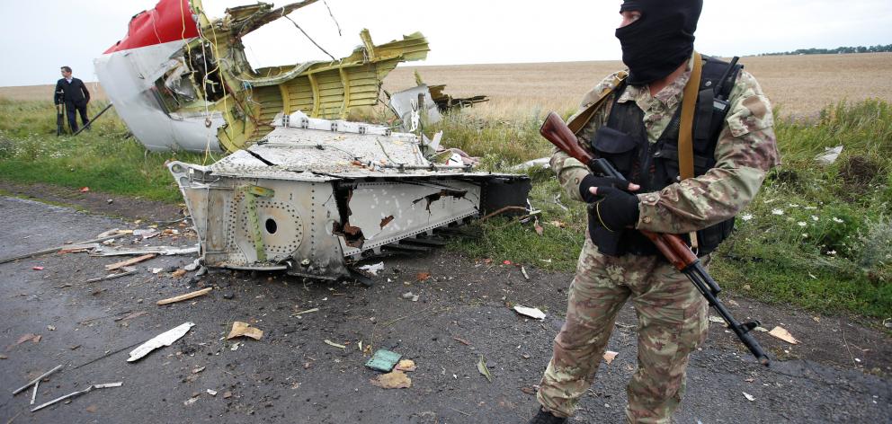 A pro-Russian separatist guards the site a day after the crash. Photo: Reuters 