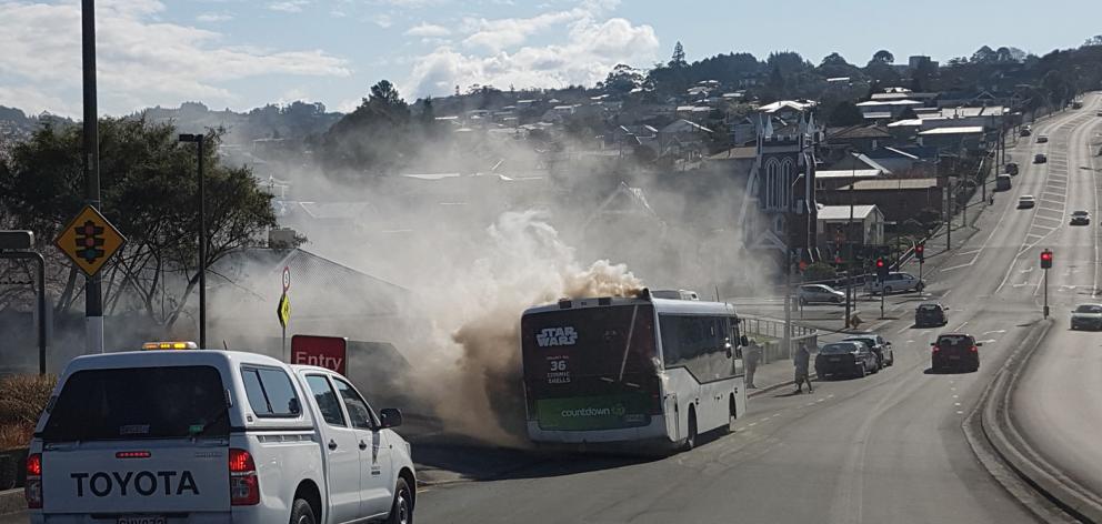 Fire takes hold in a Go Bus Transport bus in Stuart St yesterday. Photo: supplied.