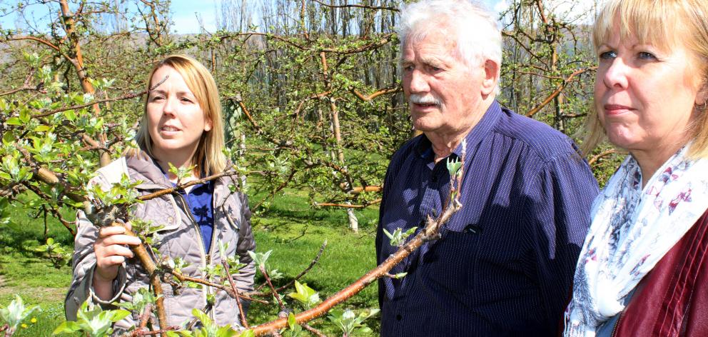 Orchardist Con van der Voort (centre) tells Port Otago customer service co-ordinator Trish Reid ...